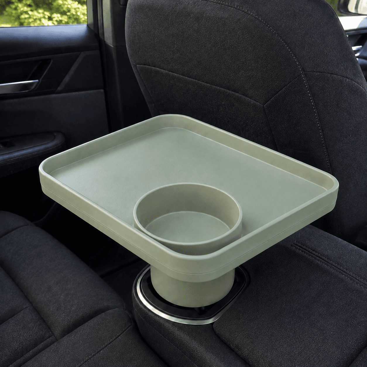 Growlet tray sitting in a car cup holder, with its own cup holder on the tray surface